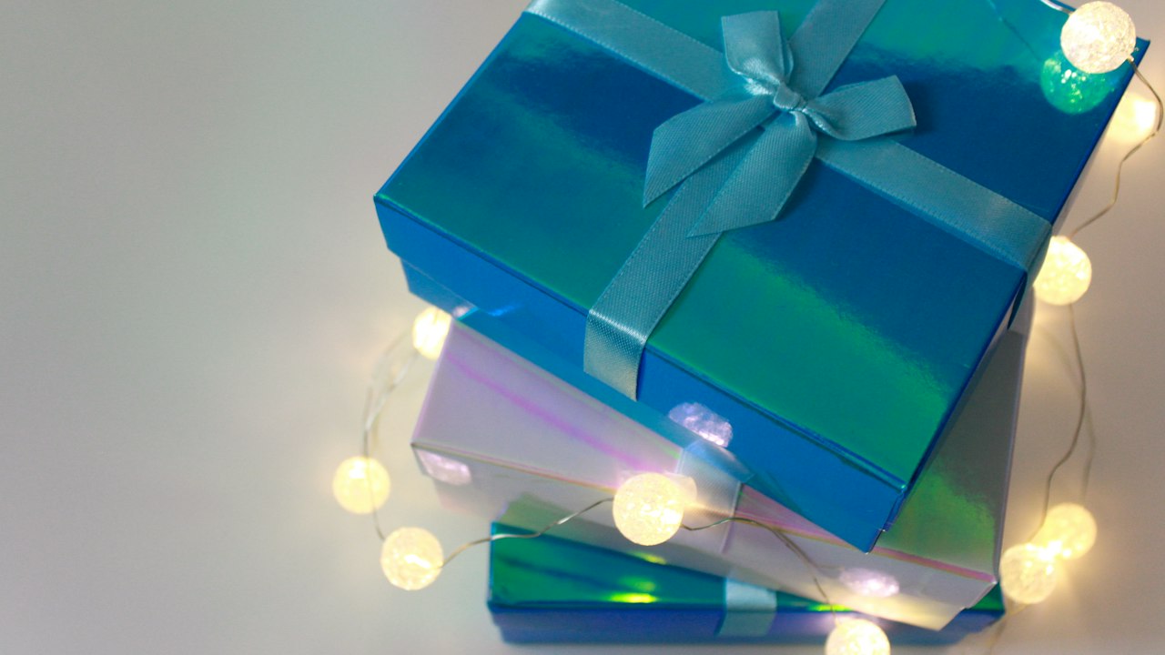Wrapped gift boxes with satin ribbon in warm light